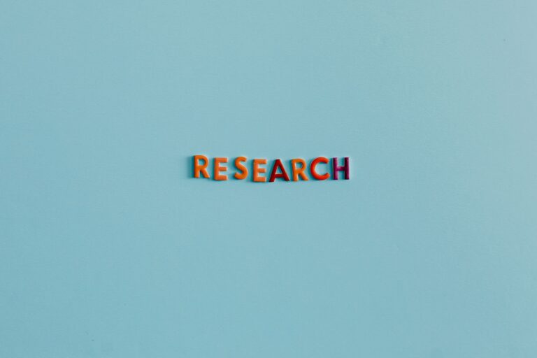 Colorful uppercase letters spelling 'RESEARCH' on a soft blue background. Ideal for education and science topics.
